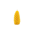 A yellow pinecone-shaped candle with a textured, layered scale design and a small white wick at the top, centered on a plain white background.