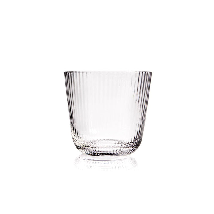 Ridged clear old fashioned glass on white background