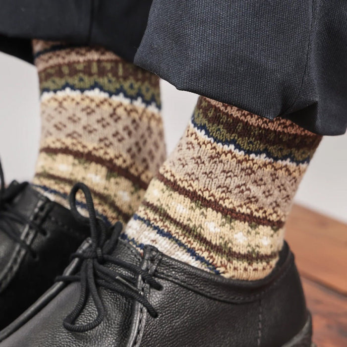 Close-up of model wearing cotton fair isle socks and black shoes.