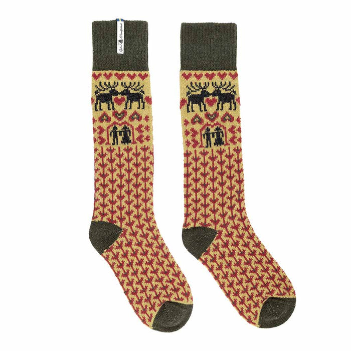 Pair of socks with yellow and green and red reindeer and houndstooth pattern on a white background