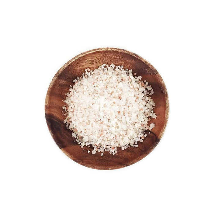 Wooden bowl filled with salt soak product on a white background