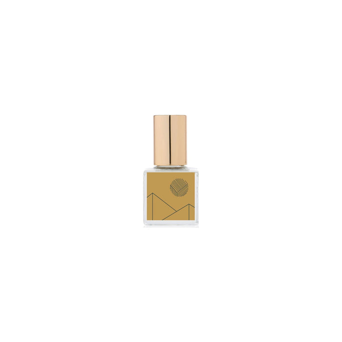 Gold perfume bottle with geometric design on a white background