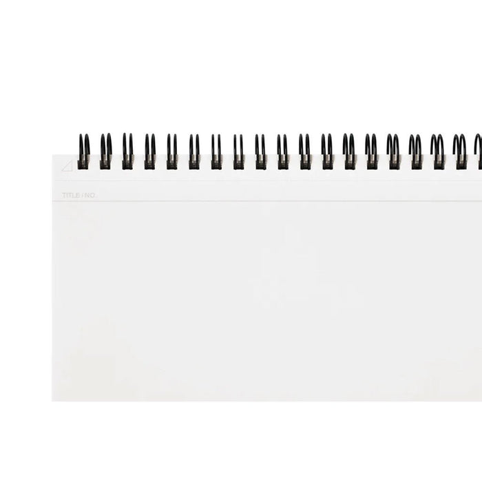 Close up of blank page in notebook with subtle header for title or page number