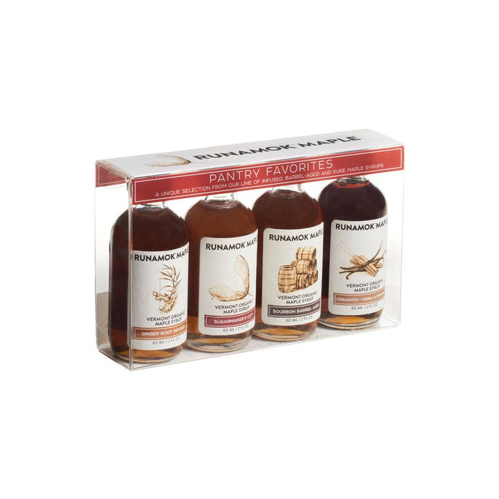 Set of four Runamok maple syrup bottles in clear packaging at an angle.