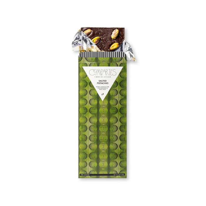 Salted pistachio chocolate bar in gold foil inside green packaging.