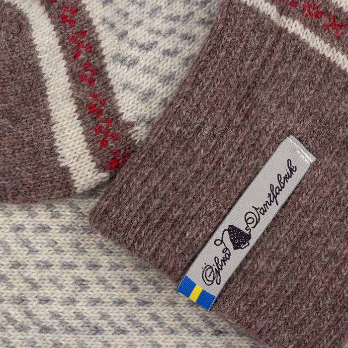 Close-up of a knitted fabric with a brand label on a textured background