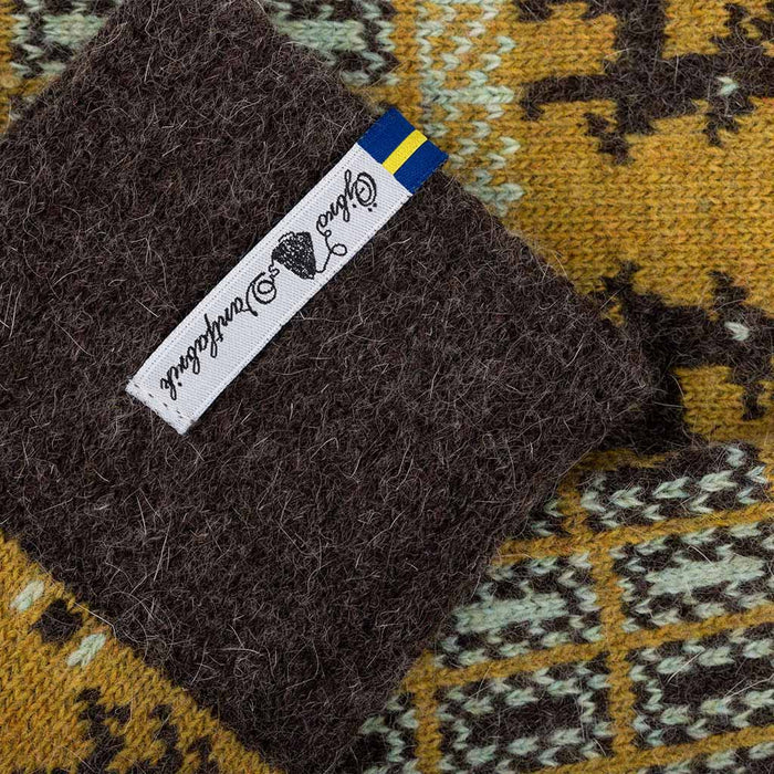 Brown textured fabric with a brand label on a patterned background